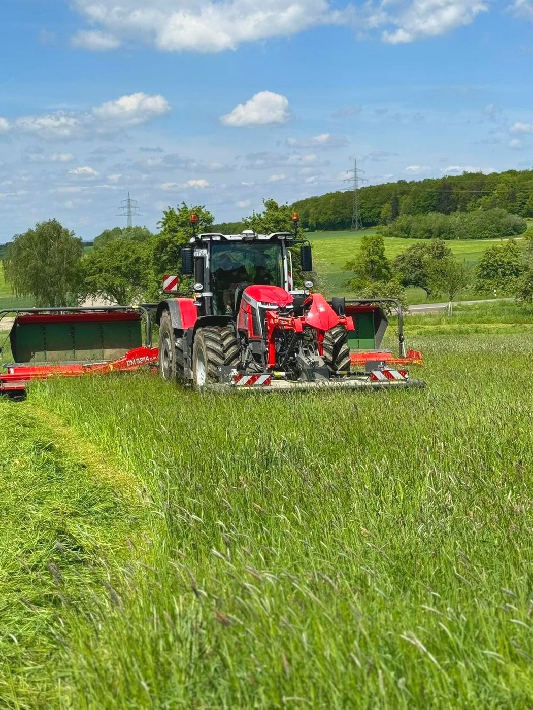 Traktor mit Mähwerk bei der Grünlandernte